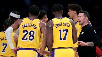 LOS ANGELES, CALIFORNIA - JANUARY 23: Head coach JJ Redick of the Los Angeles Lakers speaks with Dorian Finney-Smith #17 and Rui Hachimura #28 after a timeout during a 117-96 Lakers win over the Boston Celtics at Crypto.com Arena on January 23, 2025 in Los Angeles, California. NOTE TO USER: User expressly acknowledges and agrees that, by downloading and or using this photograph, User is consenting to the terms and conditions of the Getty Images License Agreement. Harry How/Getty Images/AFP (Photo by Harry How / GETTY IMAGES NORTH AMERICA / Getty Images via AFP)