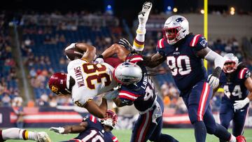 FOXBOROUGH, MA - AUGUST 12: Jonathan Williams #38 of the Washington Football Team is tackled by Harvey Langi #48 of the New England Patriots in the second half at Gillette Stadium on August 12, 2021 in Foxborough, Massachusetts.   Kathryn Riley/Getty Imag