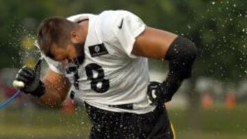 Alejandro Villanueva se refresca durante un descanso en un entrenamiento con los Pittsburgh steelers.