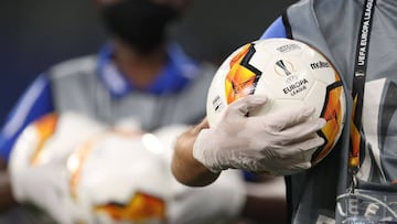 Ball boys wearing protective gloves bring the balls prior the UEFA Europa League quarter-final football match Shakhtar Donetsk v FC Basel at the Arena Aufschalke on August 11, 2020 in Gelsenkirchen, western Germany. (Photo by Lars Baron / various sources