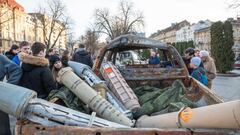 LVIV, UKRAINE - JANUARY 2: People visit the destroyed cars that were brought by volunteers from the front line near Bakhmut to show the consequences of the war and raise funds for new cars for Ukrainian soldiers in city center of Lviv, Ukraine, on January 2, 2023. (Photo by Olena Znak/Anadolu Agency via Getty Images)