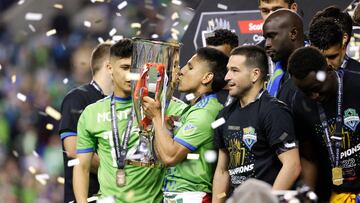 Seattle Sounders forward Raul Ruidiaz kisses the trophy as the team celebrates their victory in the CONCACAF Champions League final match between Seattle Sounders and Pumas UNAM at Lumen Field in Seattle, Washington on May 4, 2022. - The Seattle Sounders defeated Mexico's Pumas UNAM 5-2 on aggregate to win the CONCACAF Champions League on Wednesday, ending Major League Soccer's 23-year wait to lift the top club tournament for teams from North America, Central America and the Caribbean. (Photo by Jason Redmond / AFP)