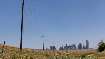FILE PHOTO: Utility poles lead to downtown Dallas during a heat advisory due to scorching weather in Dallas, Texas, U.S. July 12, 2022. REUTERS/Shelby Tauber/File Photo