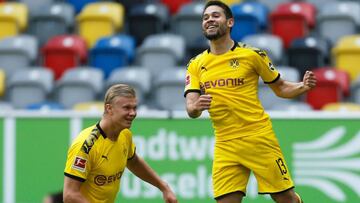 Dortmund's Portuguese defender Raphael Guerreiro (R) celebrates with Dortmund's Norwegian forward Erling Braut Haaland scoring a goal before it was ruled out by VAR during the German first division Bundesliga football match Fortuna Duesseldorf