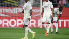 Real Madrid's Brazilian forward Vinicius Junior (L) and teammates leave the pitch after being defeated 4-2 during the Spanish league football match between Girona FC and Real Madrid CF at the Montilivi stadium in Girona on April 25, 2023. (Photo by LLUIS GENE / AFP)