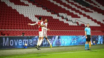 AMSTERDAM, NETHERLANDS - FEBRUARY 25: Ajax player David Neres (r) celebrates with team mate Edson Alvarez after scoring the second Ajax goal during the UEFA Europa League Round of 32 match between AFC Ajax and Lille OSC at Johan Cruijff Arena on February