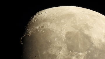 The craters on the surface of the crescent moon are seen from the northern hemisphere as it rises in the sky over Ronda.