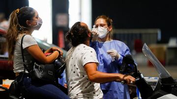A healthcare worker takes a swab sample from a man to be tested for the coronavirus disease (COVID-19), at La Rural, in Buenos Aires, Argentina December 23, 2021. Picture taken December 23, 2021. REUTERS/Agustin Marcarian