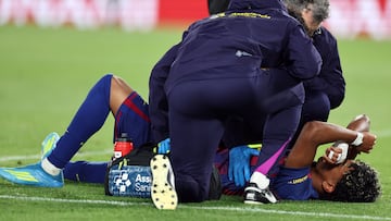 Barcelona's Spanish forward #10 Lamine Yamal receives medical attention after sustaining an injury during the Spanish league football match between FC Barcelona and RC Celta de Vigo at Camp Nou stadium in Barcelona on April 22 , 2026. (Photo by Josep LAGO / AFP)
