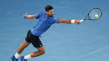 Serbia's Novak Djokovic hits a return against Czech Republic's Jiri Lehecka during their men's singles match on day eight of the Australian Open tennis tournament in Melbourne on January 19, 2025. (Photo by Adrian DENNIS / AFP) / -- IMAGE RESTRICTED TO EDITORIAL USE - STRICTLY NO COMMERCIAL USE --