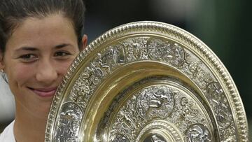Spain's Garbine Muguruza holds the winners trophy after defeating Venus Williams of the United States, in the Women's Singles final match on day twelve at the Wimbledon Tennis Championships in London Saturday, July 15, 2017. (AP Photo/Tim Ireland)