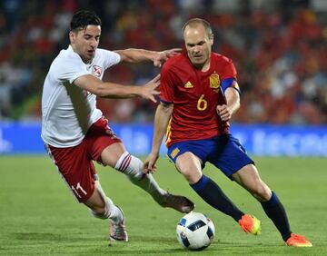 Andres Iniesta slips away from Georgia's Giorgi Chanturia