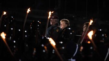 German Chancellor Angela Merkel (C), outgoing German Defence Minister Annegret Kramp-Karrenbauer (R) and Eberhard Zorn, Inspector General (L) of the Bundeswehr, the German Armed Forces follow proceedings at the Defence Ministry during the Grand Tattoo (Gr