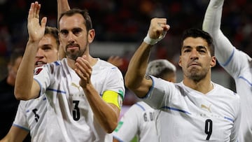 Uruguay's Luis Suarez (R) celebrates with Uruguay's Diego Godin after scoring against Chile during their South American qualification football match for the FIFA World Cup Qatar 2022 at the San Carlos de Apoquindo Stadium in Santiago on March 29