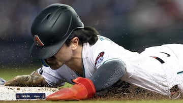 PHOENIX, ARIZONA - OCTOBER 11: Corbin Carroll #7 of the Arizona Diamondbacks dives into third base during a pickoff attempt in the fifth inning against the Los Angeles Dodgers during Game Three of the Division Series at Chase Field on October 11, 2023 in Phoenix, Arizona. Elsa/Getty Images/AFP (Photo by ELSA / GETTY IMAGES NORTH AMERICA / Getty Images via AFP)