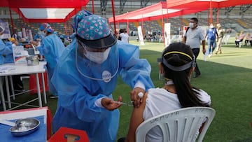 A health worker give a dose of the Sinopharm coronavirus disease (COVID-19) vaccine to a medical staff member at the stadium Ollantaytamboin Lima, Peru February 19, 2021. REUTERS/Sebastian Castaneda