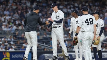 Jun 18, 2025; Bronx, New York, USA; New York Yankees relief pitcher Ryan Yarbrough (33) hands the ball to manager Aaron Boone (17) during the sixth inning against the Los Angeles Angels at Yankee Stadium. Mandatory Credit: Vincent Carchietta-Imagn Images