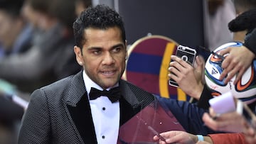 (FILES) Brazil and FC Barcelona defender Dani Alves poses on the red carpet as he arrives for the 2015 FIFA Ballon d'Or award ceremony at the Kongresshaus in Zurich on January 11, 2016. A Spanish court on February 22, 2024 sentenced former Brazil international Dani Alves to four and a half years in prison after finding him guilty of raping a young woman at a Barcelona nightclub in December 2022. (Photo by MICHAEL BUHOLZER / AFP)