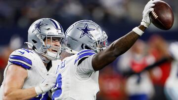 ARLINGTON, TEXAS - DECEMBER 22: Jourdan Lewis #2 celebrates with Nick Vigil #41 of the Dallas Cowboys after a fourth quarter interception against the Tampa Bay Buccaneers at AT&T Stadium on December 22, 2024 in Arlington, Texas. Ron Jenkins/Getty Images/AFP (Photo by Ron Jenkins / GETTY IMAGES NORTH AMERICA / Getty Images via AFP)