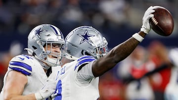 ARLINGTON, TEXAS - DECEMBER 22: Jourdan Lewis #2 celebrates with Nick Vigil #41 of the Dallas Cowboys after a fourth quarter interception against the Tampa Bay Buccaneers at AT&T Stadium on December 22, 2024 in Arlington, Texas. Ron Jenkins/Getty Images/AFP (Photo by Ron Jenkins / GETTY IMAGES NORTH AMERICA / Getty Images via AFP)