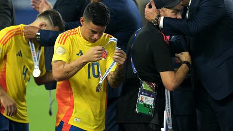 Colombia's midfielder #10 James Rodriguez takes off his medal following his team's defeat in the Conmebol 2024 Copa America tournament final football match between Argentina and Colombia at the Hard Rock Stadium, in Miami, Florida on July 14, 2024. (Photo by JUAN MABROMATA / AFP)