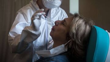 ISTANBUL, TURKEY - MAY 08: A woman reacts before having a COVID-19 nose swab test done at the Kartal Dr. Lutii Kirdar Education and Research Hospital on May 08, 2020 in Istanbul, Turkey. As of May 8, Turkey has recorded 3,689 coronavirus related deaths, 135,569 confirmed cases and 86,396 recovered patients. As numbers begin to drop Turkey has announced a tentative loosening of some restrictions but will continue weekend lockdowns. The interior ministry continues restrictions on travel between 24 cities, a curfew is still in place for people over the age of 65 and under 20, schools, cafes, bars and non-essential businesses remain closed. Chris McGrath/Getty Images/AFP
== FOR NEWSPAPERS, INTERNET, TELCOS & TELEVISION USE ONLY ==