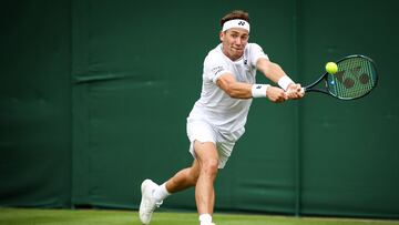 Norway's Casper Ruud returns the ball to Australia's Alex Bolt during their men's singles tennis match on the first day of the 2024 Wimbledon Championships at The All England Lawn Tennis and Croquet Club in Wimbledon, southwest London, on July 1, 2024. (Photo by HENRY NICHOLLS / AFP) / RESTRICTED TO EDITORIAL USE