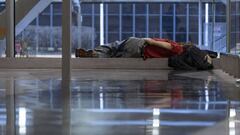 A homeless person sleeps in a window at Terminal 2 in O'Hare International Airport.