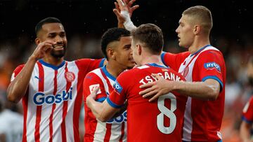 Girona's players celebrate after Valencia's Spanish defender #34 Yarek Gasiorowski scored an own-goal during the Spanish League football match between Valencia CF and Girona FC at the Mestalla stadium in Valencia on May 19, 2024. (Photo by JAIME REINA / AFP)