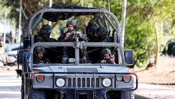Israeli soldiers patrol in a military vehicle, following a deadly infiltration by Hamas gunmen from the Gaza Strip, in Kibbutz Kfar Aza in southern Israel, October 15, 2023. REUTERS/Ronen Zvulun