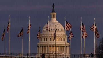 WASHINGTON, DC - DECEMBER 26: The US Capitol Building is seen past the Washington Monument as the sun sets on December 26, 2020 in Washington, DC. Lawmakers in Congress are continuing to work on the coronavirus relief package following President Donald Tr