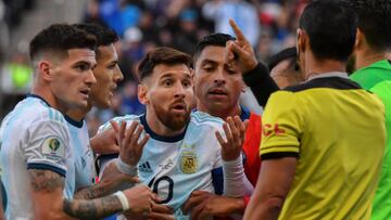 (FILES) In this file picture taken on July 6, 2019 Argentina's Lionel Messi (C) talks to Paraguayan referee Mario Diaz de Vivar after he and Chile's Gary Medel (out of frame) were sent off during their Copa America football tournament third-plac