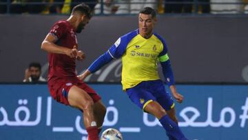 Nassr's Portuguese forward Cristiano Ronaldo (R) is marked by Abha's Iraqi defender Saad Natiq during the Saudi Pro League football match between Abha and al-Nassr at Mrsool Park Stadium in Riyadh on March 18, 2023. (Photo by Fayez NURELDINE / AFP) (Photo by FAYEZ NURELDINE/AFP via Getty Images)
