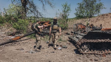 LUHANSK, UKRAINE - JUNE 9: Ukrainian soldiers next to a destroyed Russian tank on the frontline in Luhansk oblast, Ukraine, on June 09, 2022. (Photo by Diego Herrera Carcedo/Anadolu Agency via Getty Images)