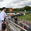 Spain's Carlos Alcaraz throws balls to wainting fans after taking part in a training session on the eve of his men's final tennis match, at the Aorangi Practice Courts, on the thirteenth day of the 2024 Wimbledon Championships at The All England Lawn Tennis and Croquet Club in Wimbledon, southwest London, on July 13, 2024. Alcaraz will face Serbia's Novak Djokovic in the men's final on July 14. (Photo by ANDREJ ISAKOVIC / AFP) / RESTRICTED TO EDITORIAL USE