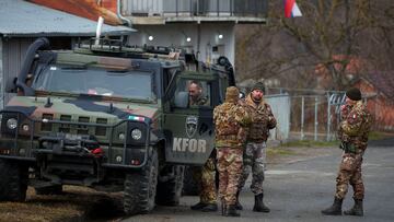 Members of the Italian Armed Forces, part of the NATO peacekeepers mission in Kosovo, stand guard near a roadblock in Rudare, near the northern part of the ethnically-divided town of Mitrovica, Kosovo, December 28, 2022. REUTERS/Florion Goga