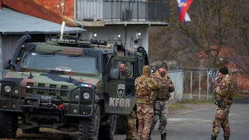 Members of the Italian Armed Forces, part of the NATO peacekeepers mission in Kosovo, stand guard near a roadblock in Rudare, near the northern part of the ethnically-divided town of Mitrovica, Kosovo, December 28, 2022. REUTERS/Florion Goga