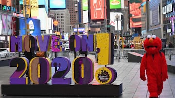 A person dressed as Elmo walks past a sign reading &#039;Move On 2020!&#039; at Times Square on December 28, 2020 in New York City. (Photo by Angela Weiss / AFP)