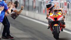 Repsol Honda Team's Spanish rider Pol Espargaro (R) celebrates with teammates as he finishes third during the Moto GP Grand Prix of Qatar at the Lusail International Circuit, in the city of Lusail on March 6, 2022. (Photo by KARIM JAAFAR / AFP)