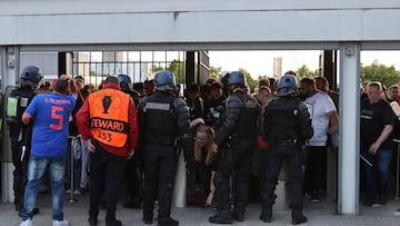(FILES) In this file photo taken on May 28, 2022 Police patrol at the gates as some fans were prevented from getting inside prior to the UEFA Champions League final football match between Liverpool and Real Madrid at the Stade de France in Saint-Denis, north of Paris. - The French Senate on May 13, 2022 hands over its report to determine the responsibilities on the security failures during the 2022 Champions League final at the Stade de France, and proposals to avoid similar situations during the 2024 Paris Olympics. (Photo by THOMAS COEX / AFP)