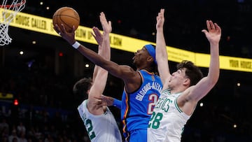 Oklahoma City Thunder guard Shai Gilgeous-Alexander (2) goes up for a basket between Boston Celtics center Luka Garza (52) and guard Hugo González (28) during the second quarter at Paycom Center.