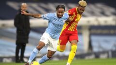MANCHESTER, ENGLAND - DECEMBER 15: Raheem Sterling of Manchester City is challenged by Grady Diangana of West Bromwich Albion during the Premier League match between Manchester City and West Bromwich Albion at Etihad Stadium on December 15, 2020 in Manche
