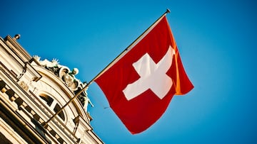 swiss flag waving on historic building
