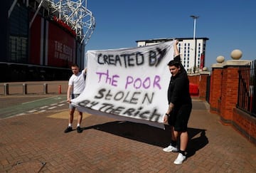 Manchester United fans hold an anti Super League banner outside Old Trafford.