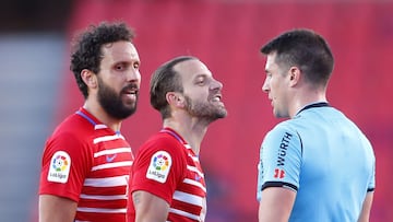 GRANADA, SPAIN - MAY 02: German Sanchez and Roberto Soldado of Granada CF interact with Match Referee, Isidro Diaz de Mera Escuderos during the La Liga Santander match between Granada CF and Cadiz CF at Estadio Nuevo Los Carmenes on May 02, 2021 in Granad