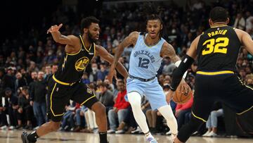 Jan 11, 2022; Memphis, Tennessee, USA; Memphis Grizzles guard Ja Morant (12) drives to the basket as Golden State Warriors forward Andrew Wiggins (22) defends during the second half at FedExForum. Mandatory Credit: Petre Thomas-USA TODAY Sports