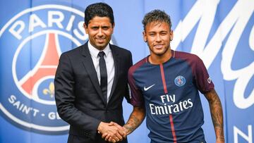 TOPSHOT - Brazilian superstar Neymar (R) shakes hands with Paris Saint Germain&#039;s (PSG) Qatari president Nasser Al-Khelaifi during a press conference at the Parc des Princes stadium on August 4, 2017 in Paris after agreeing a five-year contract follow