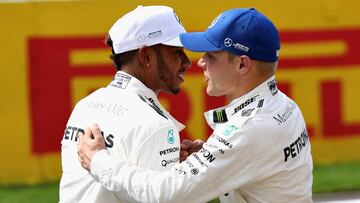 SPA, BELGIUM - AUGUST 26: Pole position qualifier Lewis Hamilton of Great Britain and Mercedes GP is congratulated by third placed qualifier and teammate Valtteri Bottas of Finland and Mercedes GP during qualifying for the Formula One Grand Prix of Belgium at Circuit de Spa-Francorchamps on August 26, 2017 in Spa, Belgium. (Photo by Mark Thompson/Getty Images)