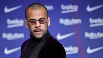 (FILES) New FC Barcelona's Brazilian defender Dani Alves, looks on during his presentation ceremony at the Camp Nou stadium in Barcelona on November 17, 2021. A Spanish court on February 22, 2024 sentenced former Brazil international Dani Alves to four and a half years in prison after finding him guilty of raping a young woman at a Barcelona nightclub in December 2022. (Photo by Pau BARRENA / AFP)