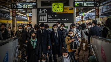 TOKYO, JAPAN - MARCH 18: People wearing face masks pass through a train station on March 18, 2022 in Tokyo, Japan. The Japanese government has announced it will lift coronavirus quasi-emergency measures that still cover a number of prefectures, including 